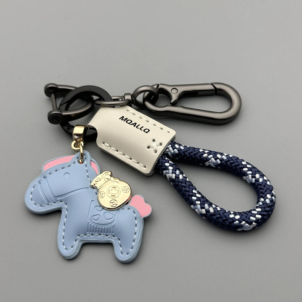 Handmade brown cowhide leather key ring with a zinc alloy pendant charm on a green flannel rope.
