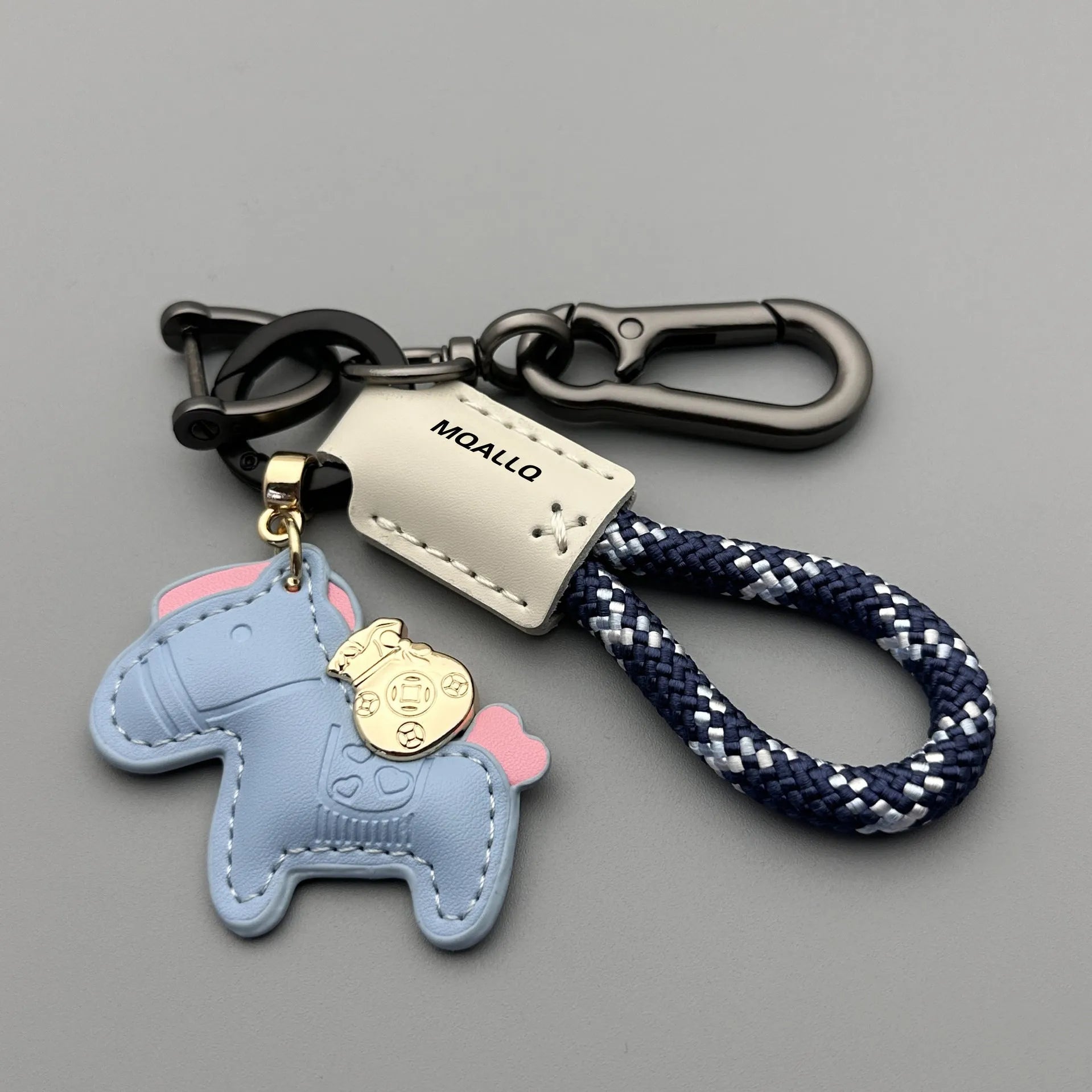 Handmade brown cowhide leather key ring with a zinc alloy pendant charm on a green flannel rope.