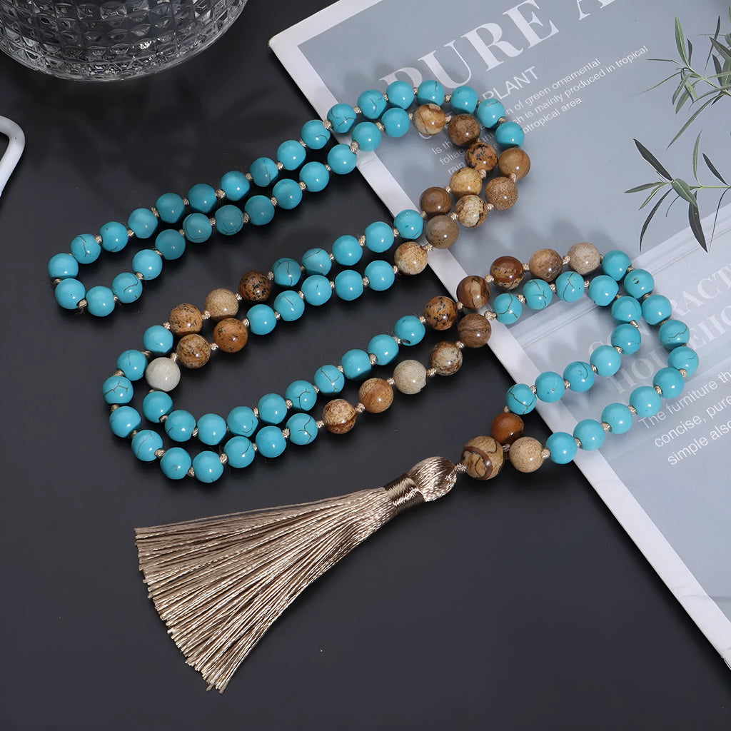 Handmade blue pine turquoise stone mala necklace with ball beads on a white background.