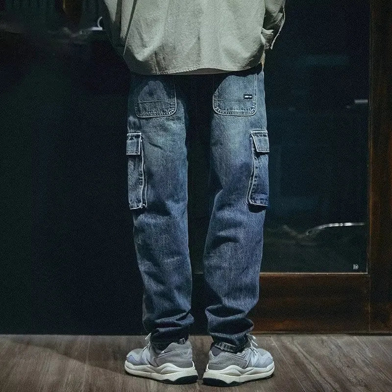 Men's loose straight-leg blue stretch denim jeans with a zip fly, shown on a hanger.