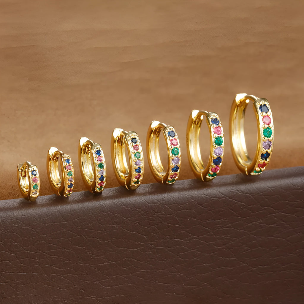 Gold, rose gold, and silver coloured perforated circle zircon stud earrings in various sizes from 5mm to 12mm.