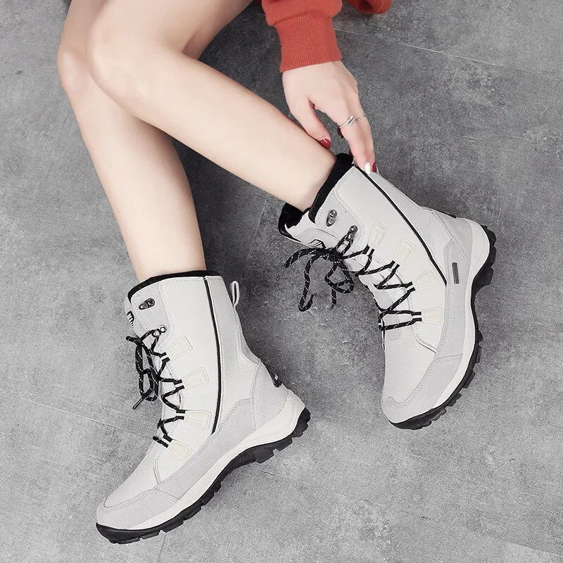 Women's black genuine leather mid-calf snow boots with round toe and thermal lining on a white background.