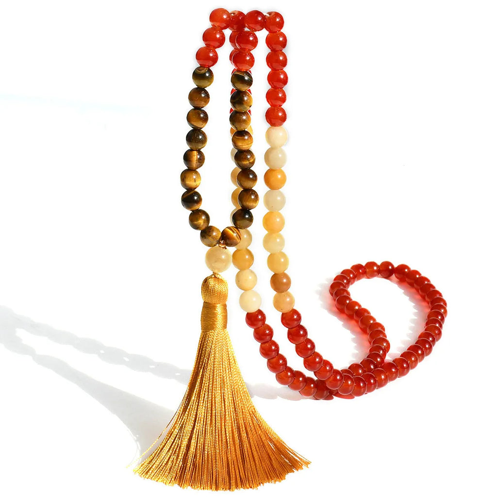 A long bohemian-style necklace with a geometric mixed gemstone pendant and a coloured tassel on a ball bead chain.