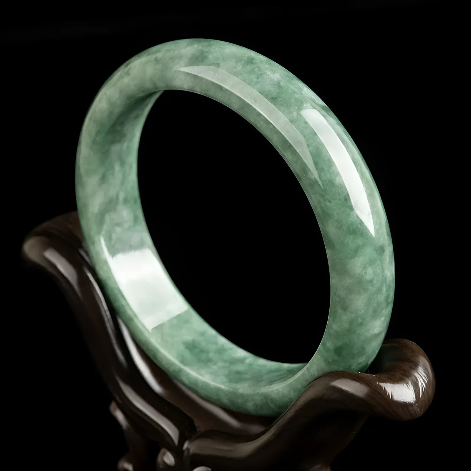 Natural deep pea green jade bangle bracelet for women on a gift box.