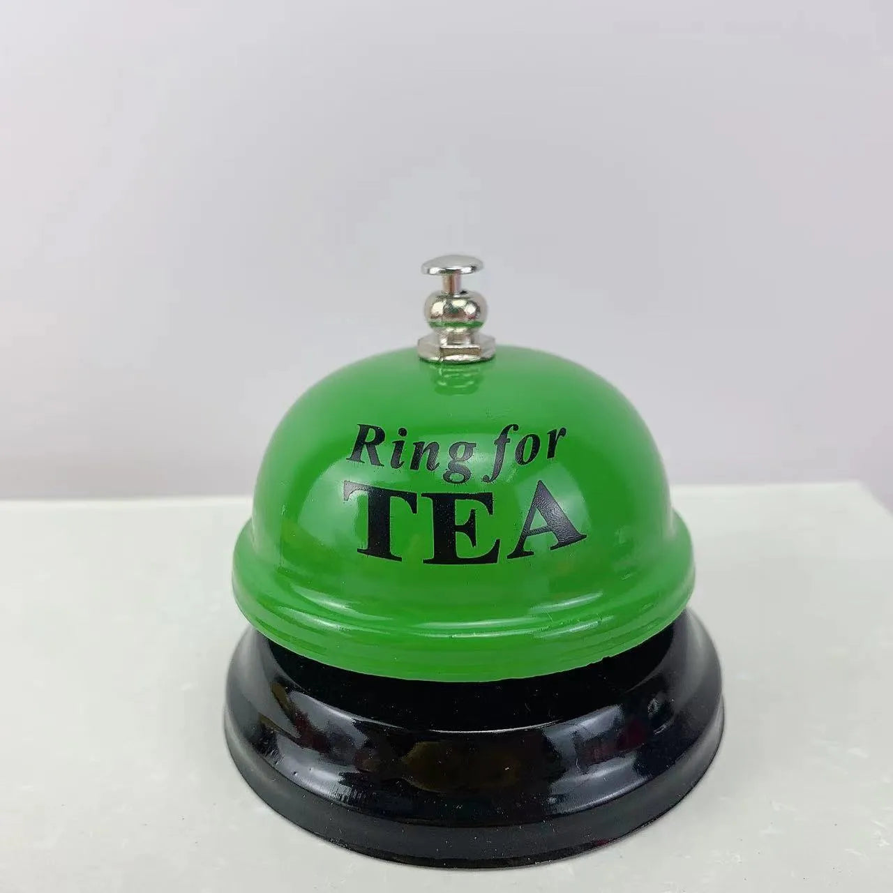 Iron game bell in assorted colours including red, blue, green, pink, and yellow for service or classroom use.