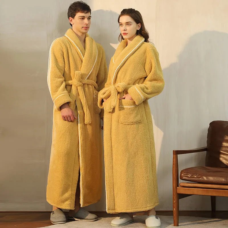 A man and woman wearing matching thick, navy blue flannel bathrobes in a European style cut.
