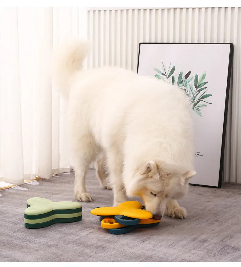 Green and yellow interactive dog puzzle toy slow feeder bowl with nine bone-covered compartments.