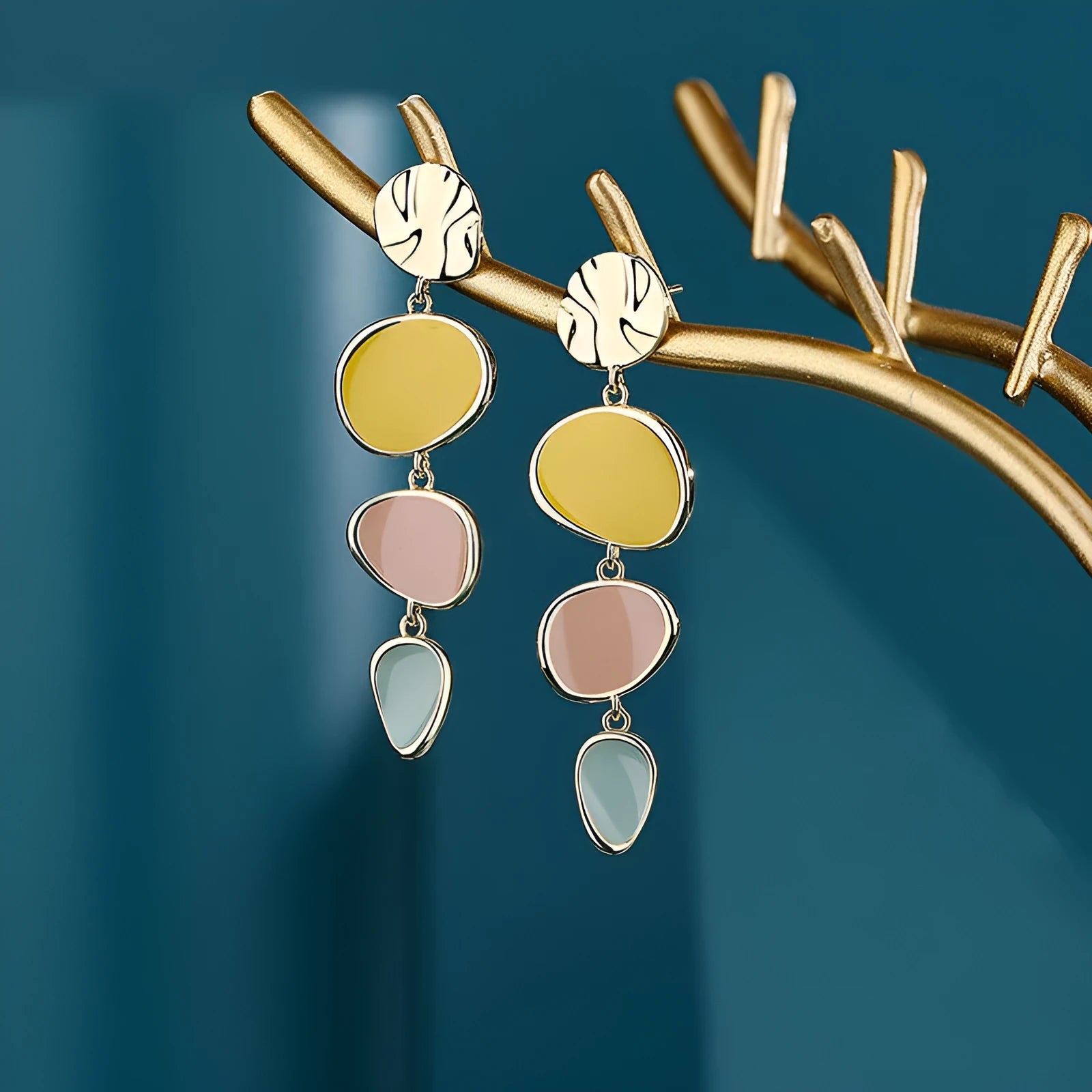 A pair of simple disc-shaped alloy earrings with a Morandi three-colour oil-drip wash finish.