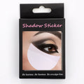 Pack of half-moon shaped disposable under-eye makeup shields on pink background