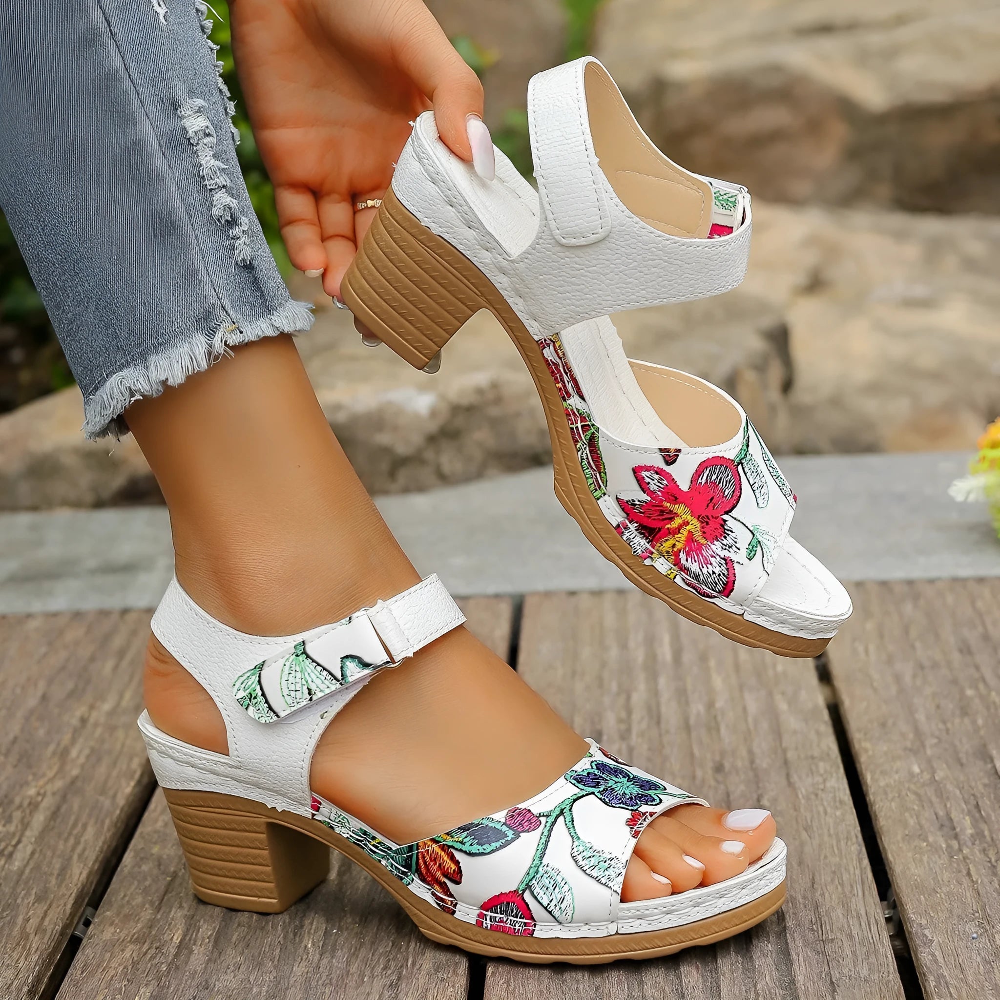 White women's high heel sandals with a Velcro strap buckle on the ankle.