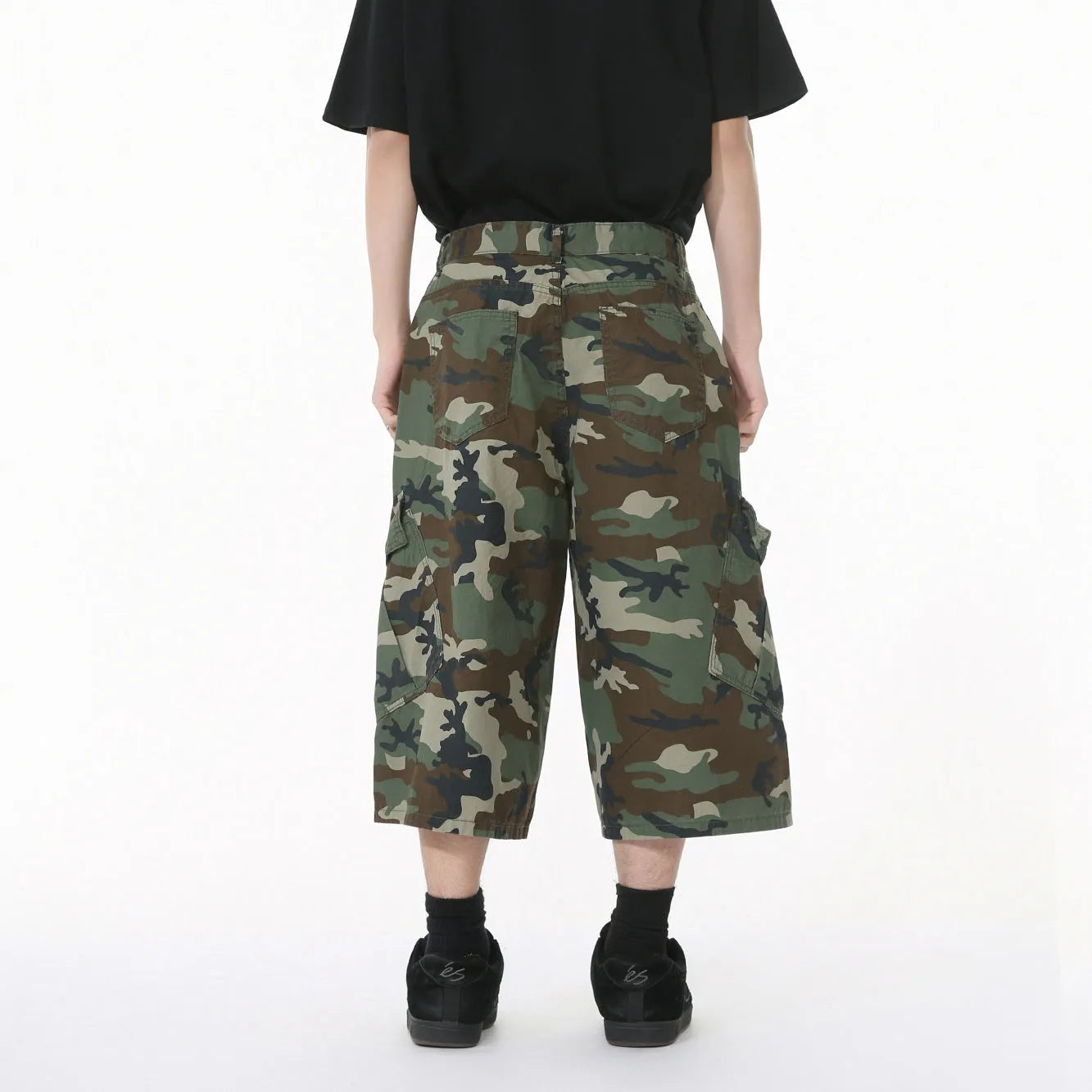 Men's camouflage print cotton jeans with a wide leg, cropped length, and large front pockets.