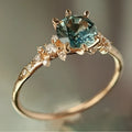 Gold plated geometric ring with claw-set zircon stones in a chamfered square design.