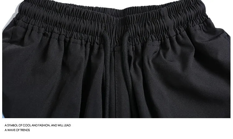 Quick-drying black and grey sports shorts with elastic waist and loose fit design