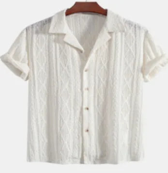 Man wearing a loose black cotton-linen blend casual cardigan shirt on a beach.