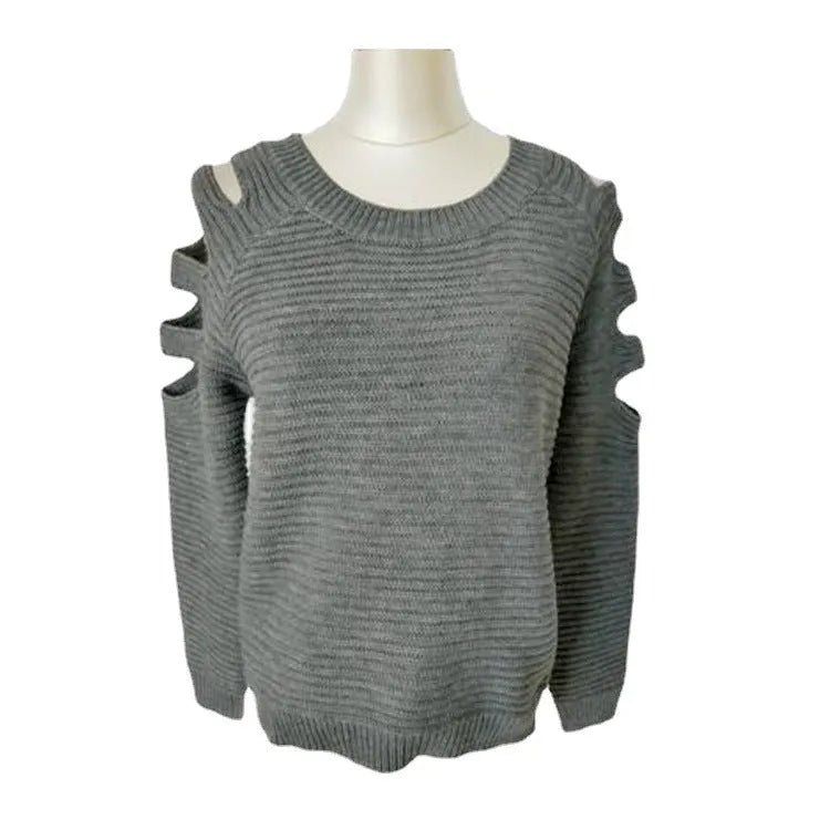 White women's knitted long sleeve shirt with hollow-out crochet detail on a hanger.