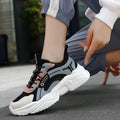 White women's casual sport shoes with a mesh upper, thick PU sole, buckle detail, and round toe.