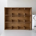 Solid birch wood cup storage rack with square compartments organising mugs on kitchen counter
