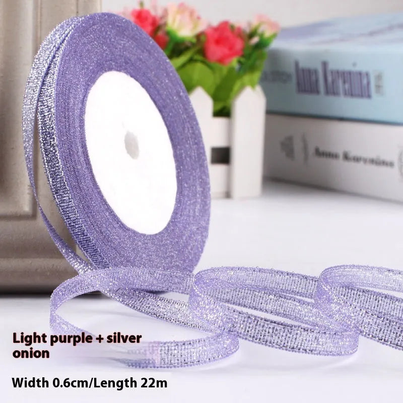 Roll of narrow 0.6cm wide polyester gift ribbon in a multicolour pattern.