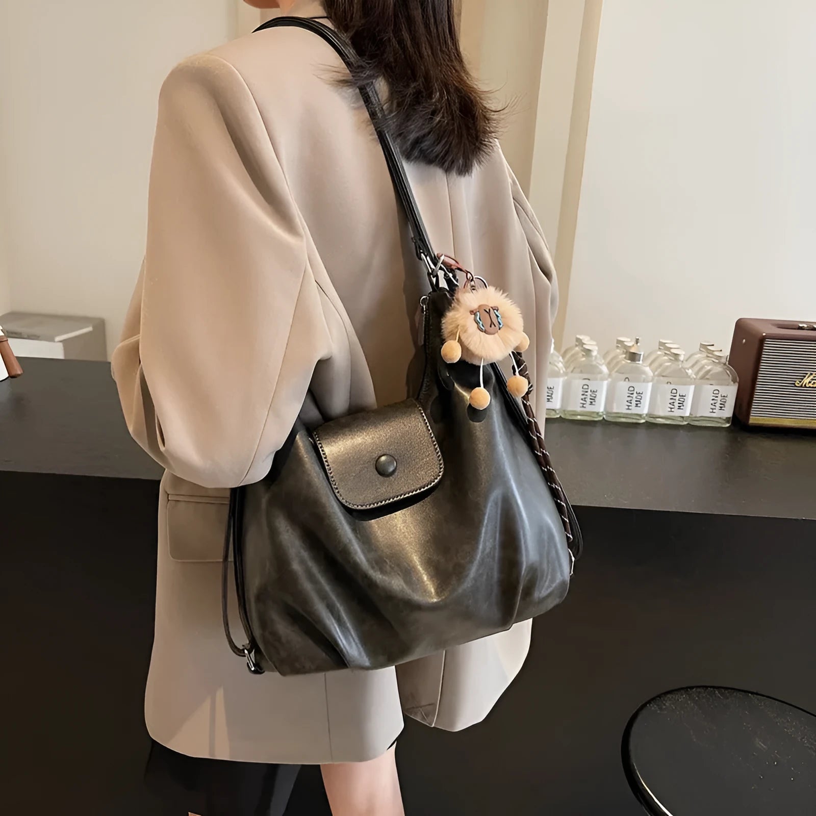 Women's PU leather shoulder bag with single strap, horizontal square design, and internal phone pouch in black colour
