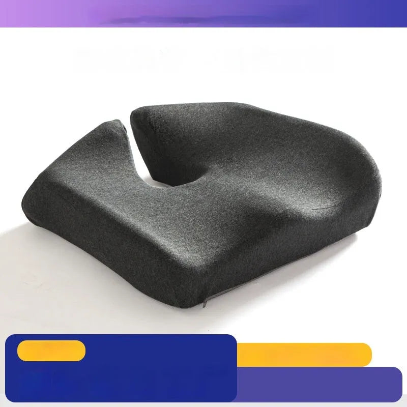 Dark grey memory foam office chair cushion for lumbar support on a desk chair.