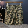 Man wearing loose-fit camouflage cargo shorts with cargo pockets and an elasticated waistband.