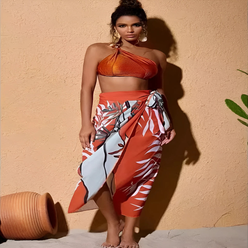 Women's brown push up high waist swimsuit with a split brief design and a sheer black chiffon dress overlay.