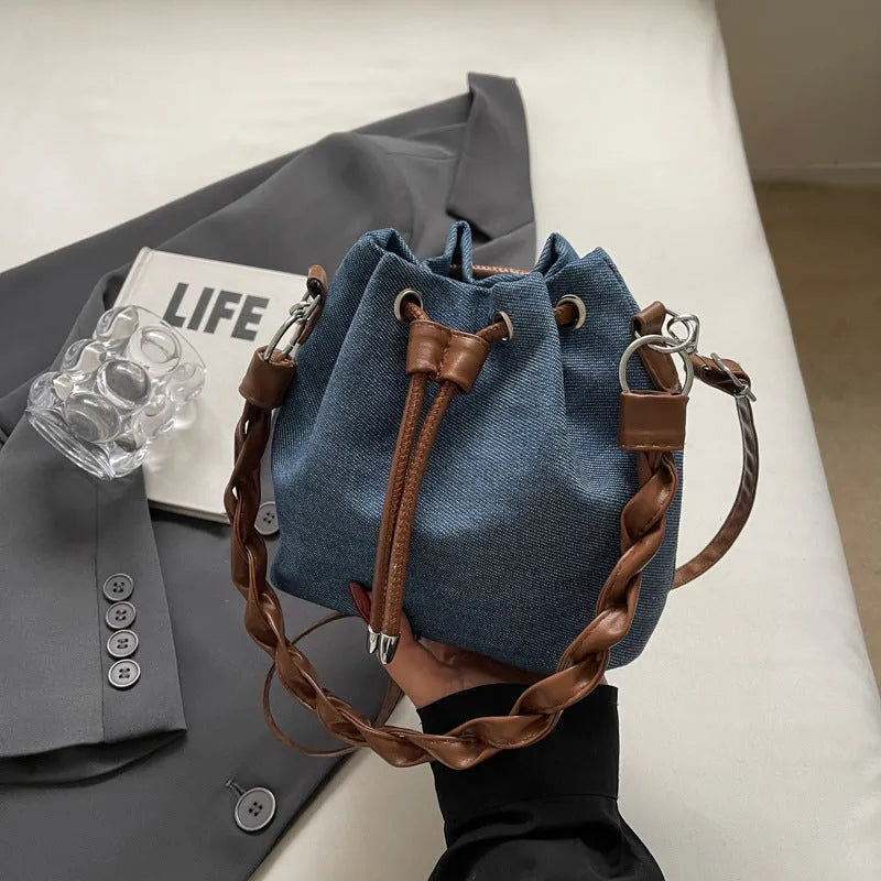 Blue one-shoulder cross body bucket bag with synthetic leather lining and sandwich pocket