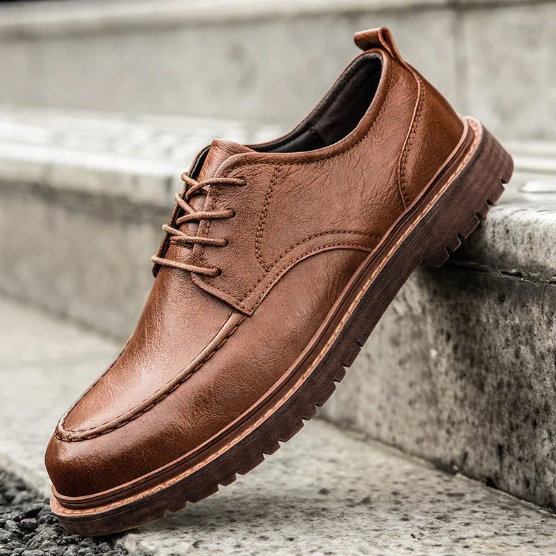 Men's black and brown British-style casual leather shoes with round toe and flat rubber sole.