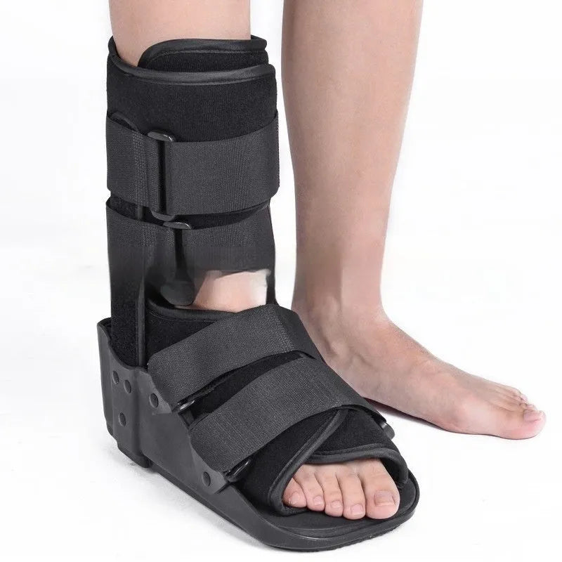 Grey and black Achilles tendon rehabilitation boot with adjustable straps and rocker sole for walking support.