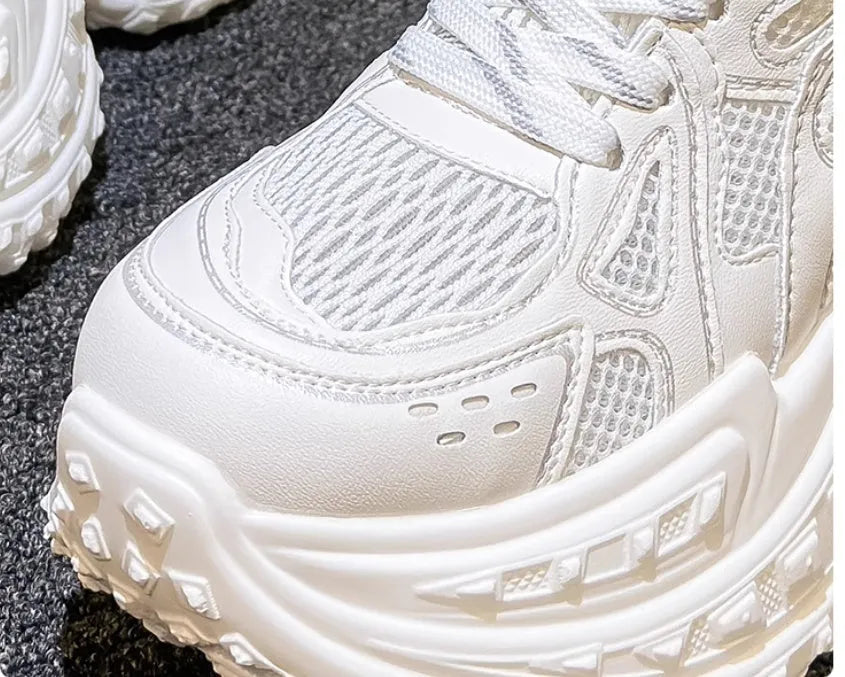 White women's lace-up dad shoes with a round toe and chunky sole for height increase.