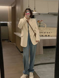 Korean-style light beige polyester small suit jacket with long sleeves and pockets on a model.