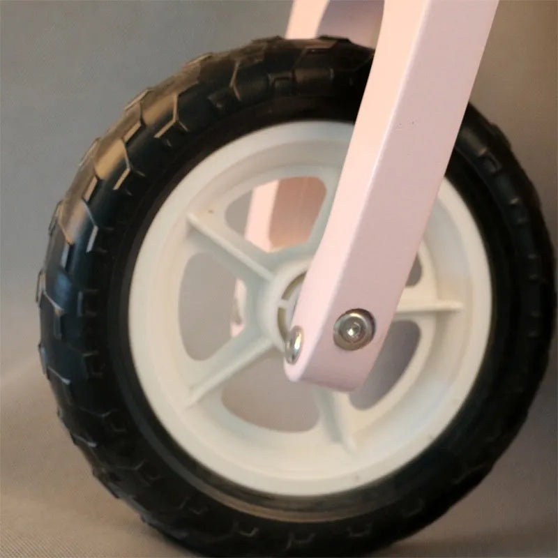 Pink wooden balance scooter for toddlers and children, 10 inches in size.