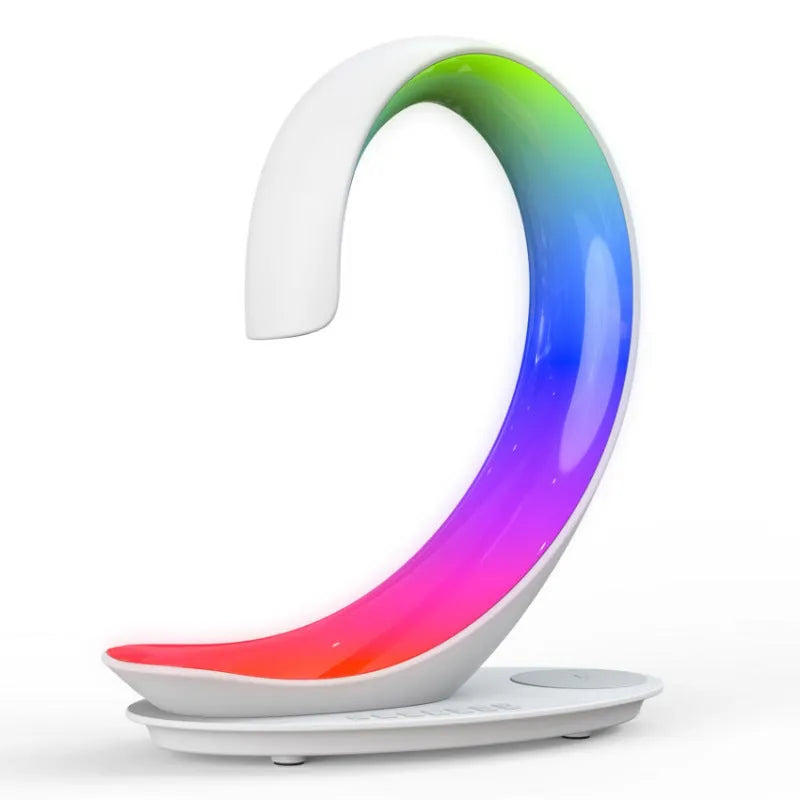 White swan-shaped desktop LED lamp with wireless charging pad and Bluetooth speaker.