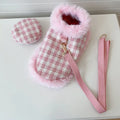 Cat wearing pink polyester cloak costume with beret and hand-holding rope