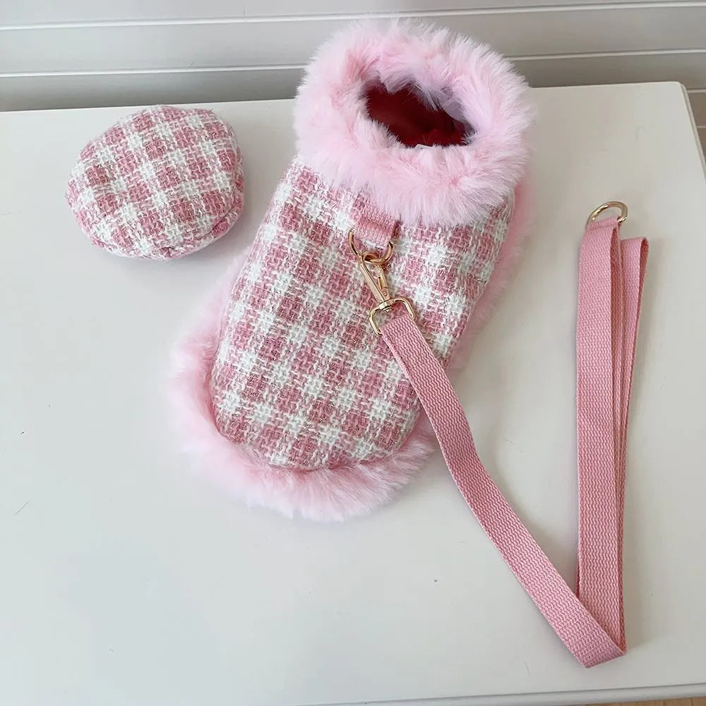 Cat wearing pink polyester cloak costume with beret and hand-holding rope