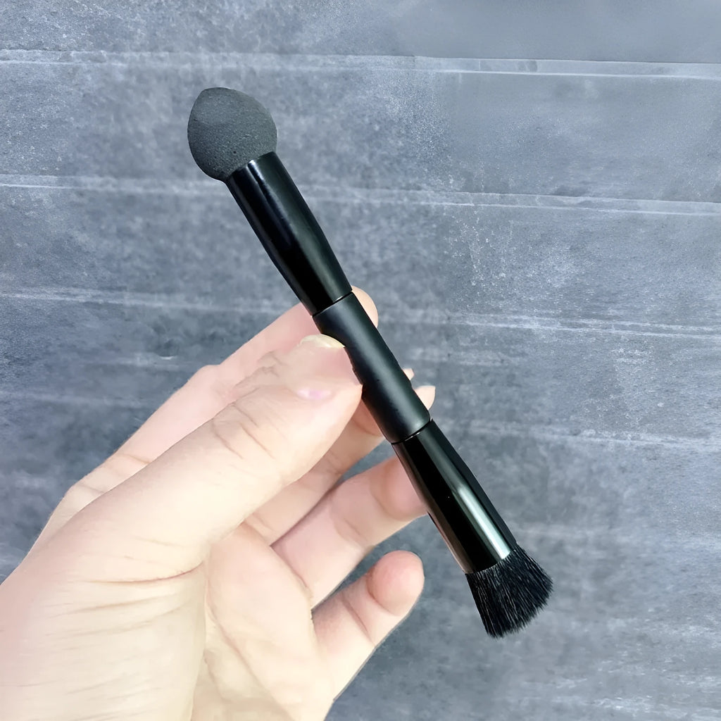 Black concealer brush with angled sponge tip and wooden handle for dark circle coverage