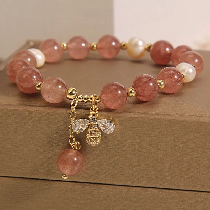 Women's bracelet with pink strawberry quartz stones, white freshwater pearls, and sparkling zircon on an alloy chain.
