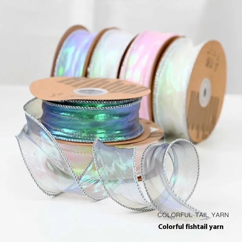 Roll of 4cm wide colourful mesh ribbon with fishtail yarn floral wave design.