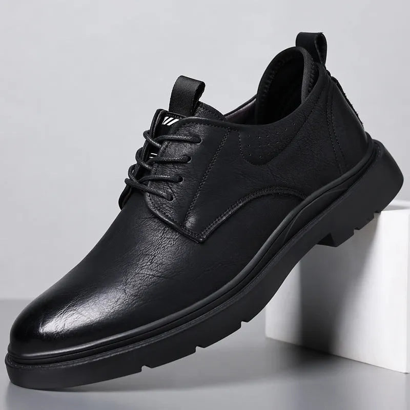 Men's black leather casual sneakers with sewing line detail and a rubber sole.