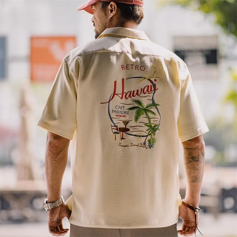 Men's light apricot shirt with bamboo leaf pattern and a Cuban collar on a short sleeve design.