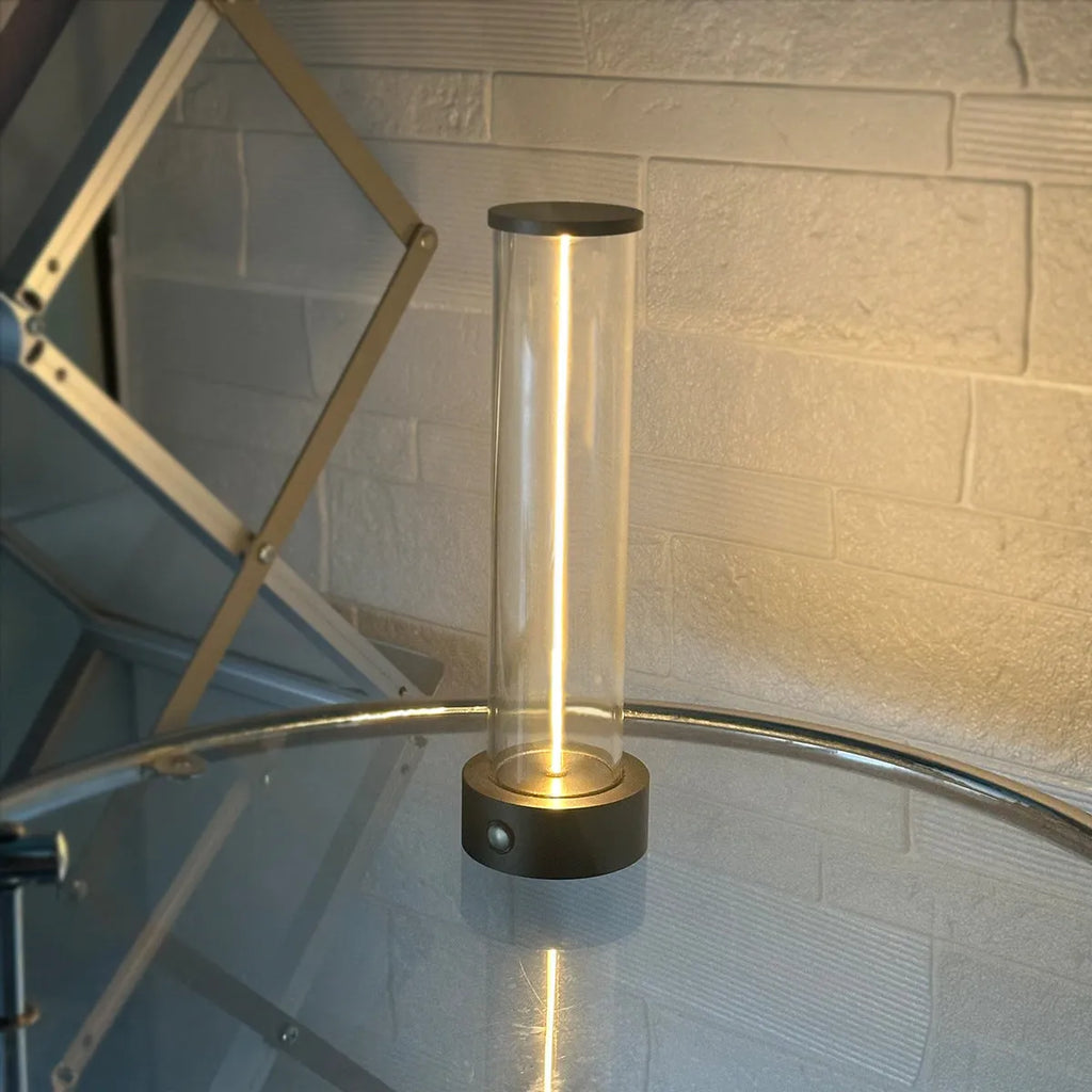 Modern glass USB LED night light with magnetic strip on a metal surface.