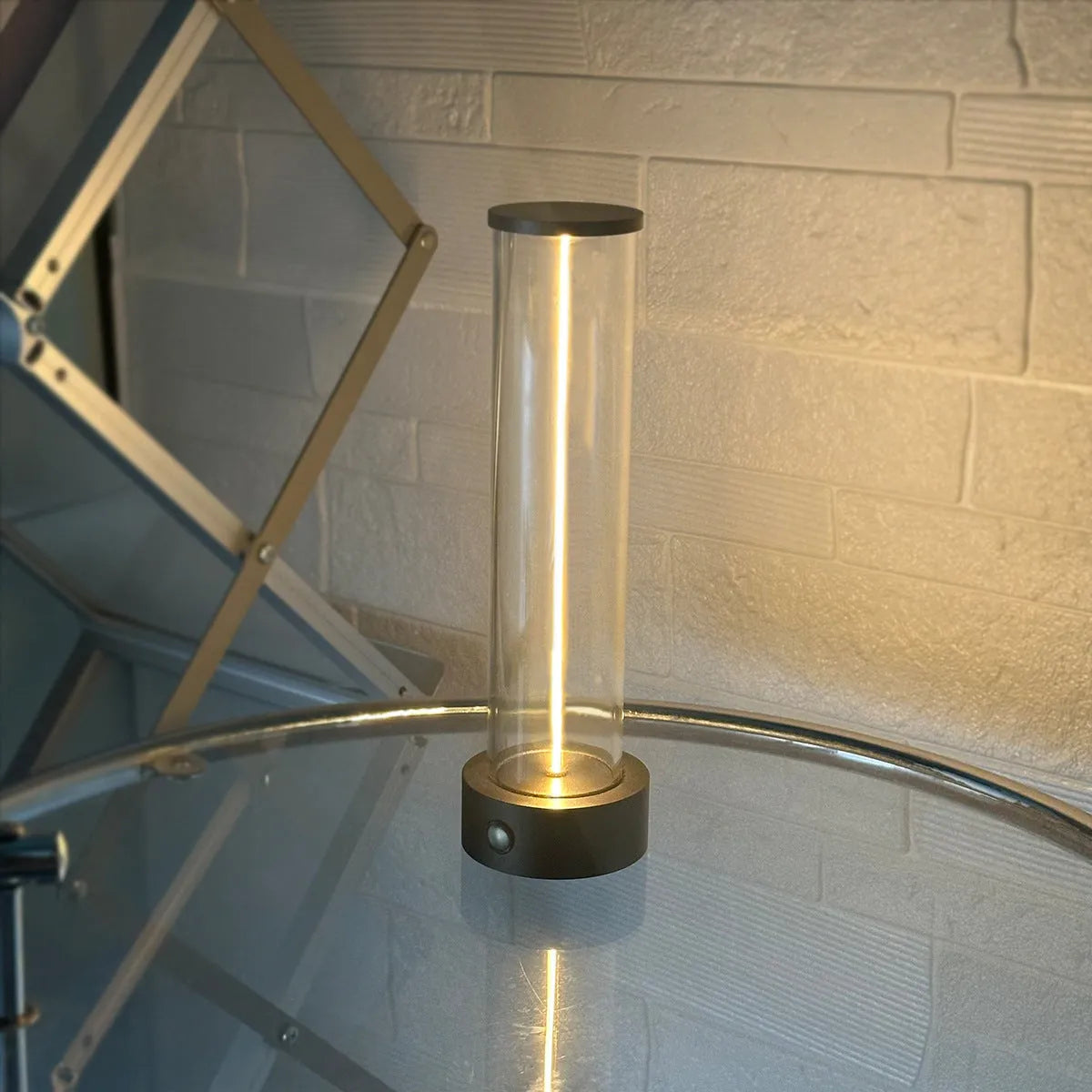 Modern glass USB LED night light with magnetic strip on a metal surface.