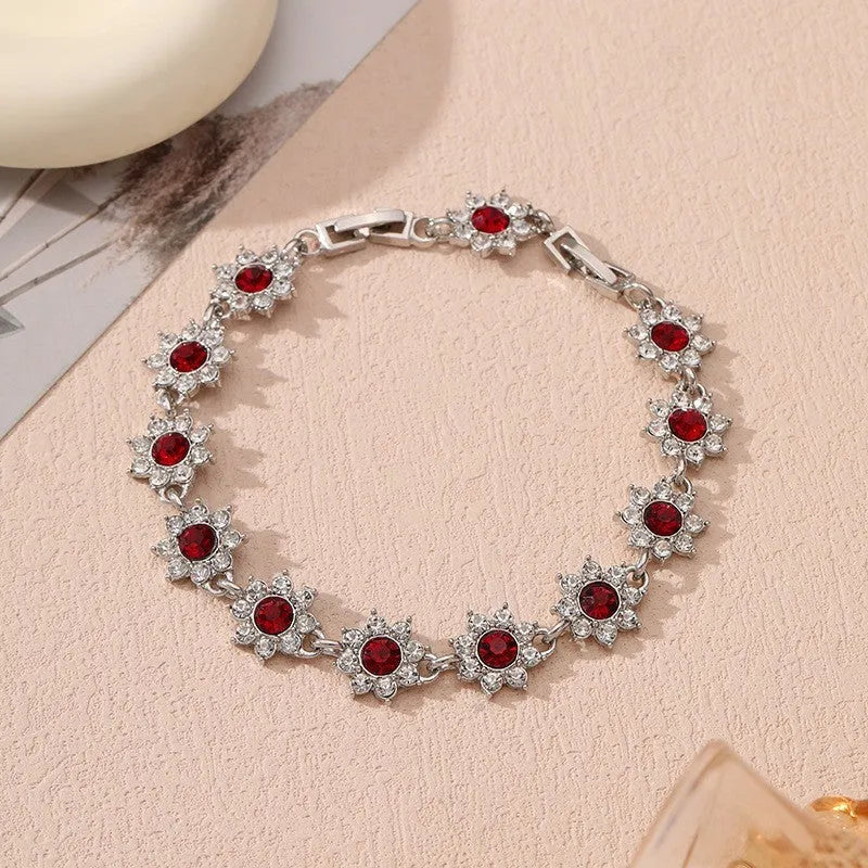Floral zinc alloy bracelet in electroplated gold and silver colour variants with crystal and diamond effects