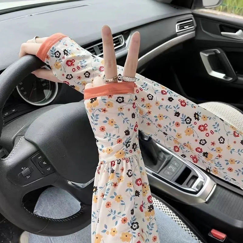 A pair of lightweight ice silk sun protection sleeve gloves in a floral print pattern, covering from wrist to elbow.