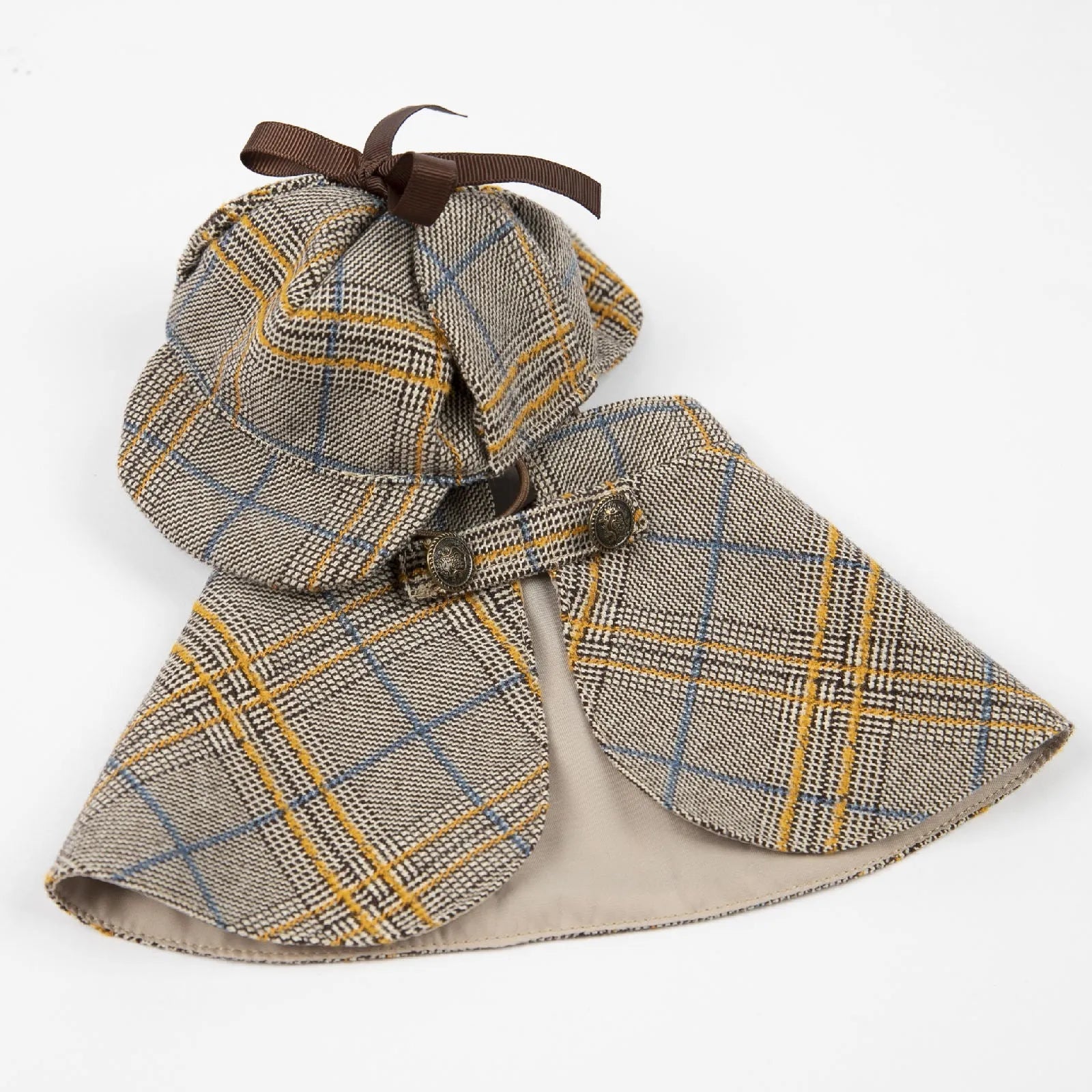 Camel-coloured cotton dog cloak with adjustable hood shown on a small breed dog.