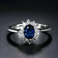 Copper floral women's ring with inlaid zirconia stone in green, blue, or red colour on a white background.