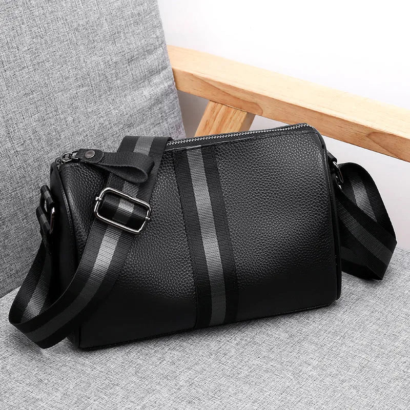 Black genuine leather crossbody bag showing 24x16x13cm dimensions with one-shoulder strap