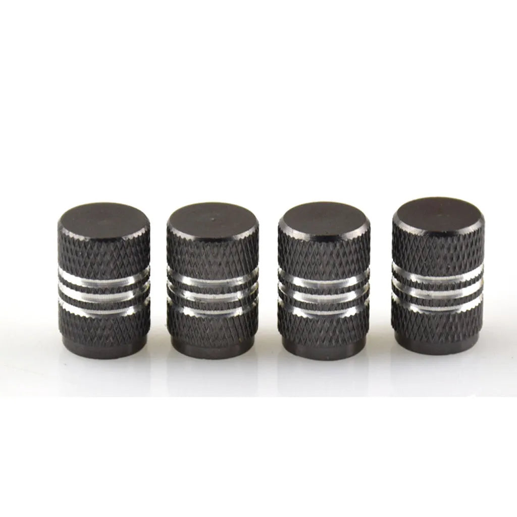Assortment of aluminium alloy car tyre valve caps in ten different colours on a grey background.