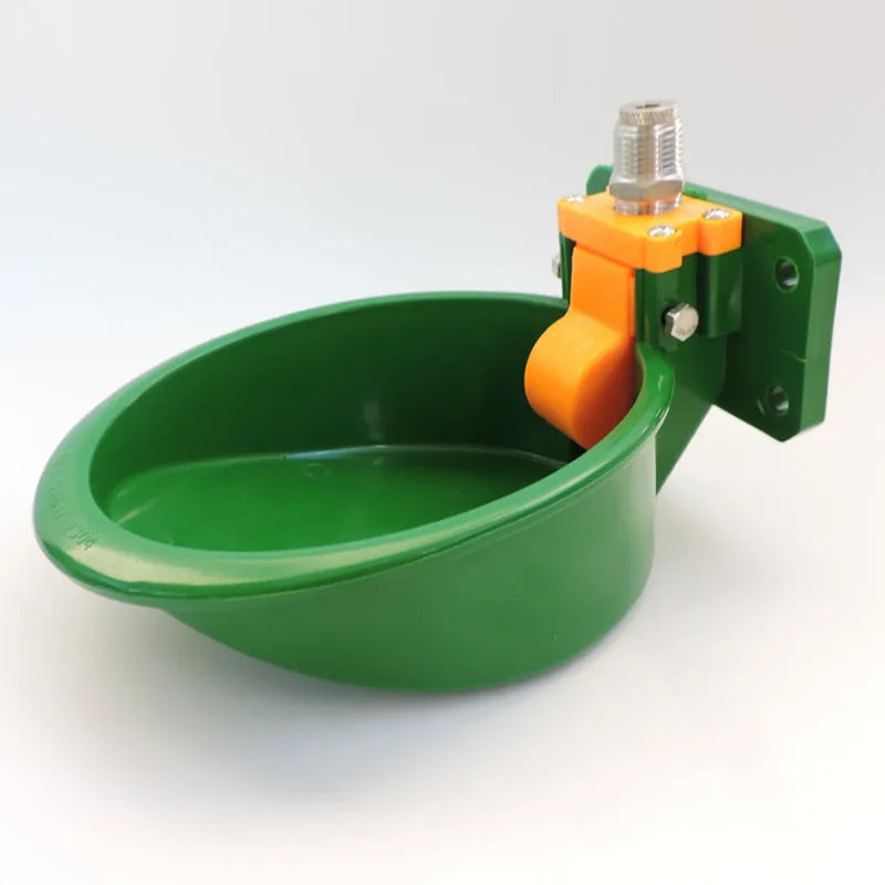 Green plastic automatic drinking bowl for sheep and pigs on farms