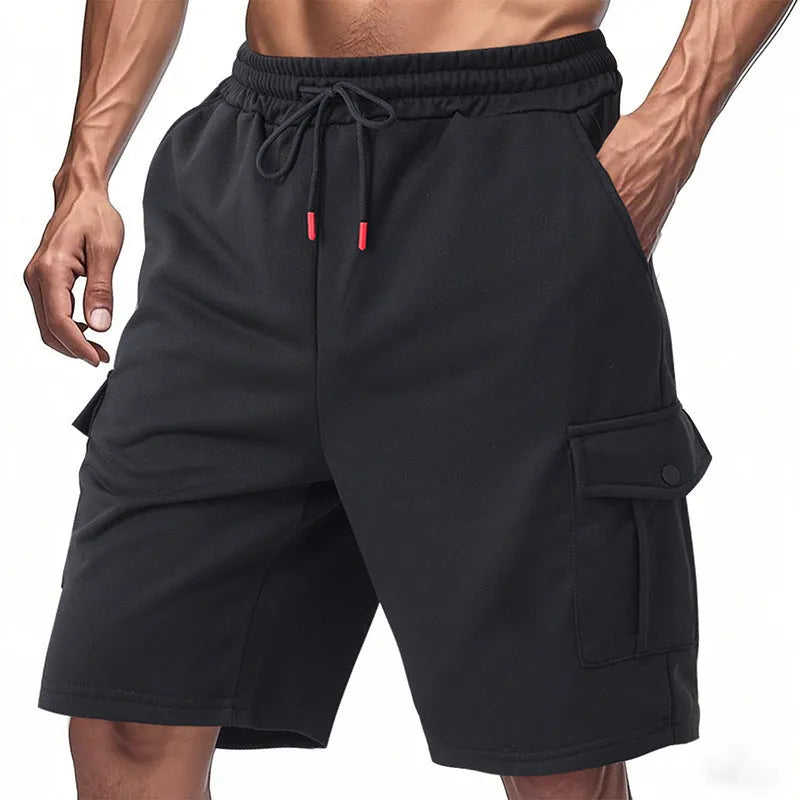 Men's loose-fit grey terry fabric cargo shorts with multiple pockets on a plain background.